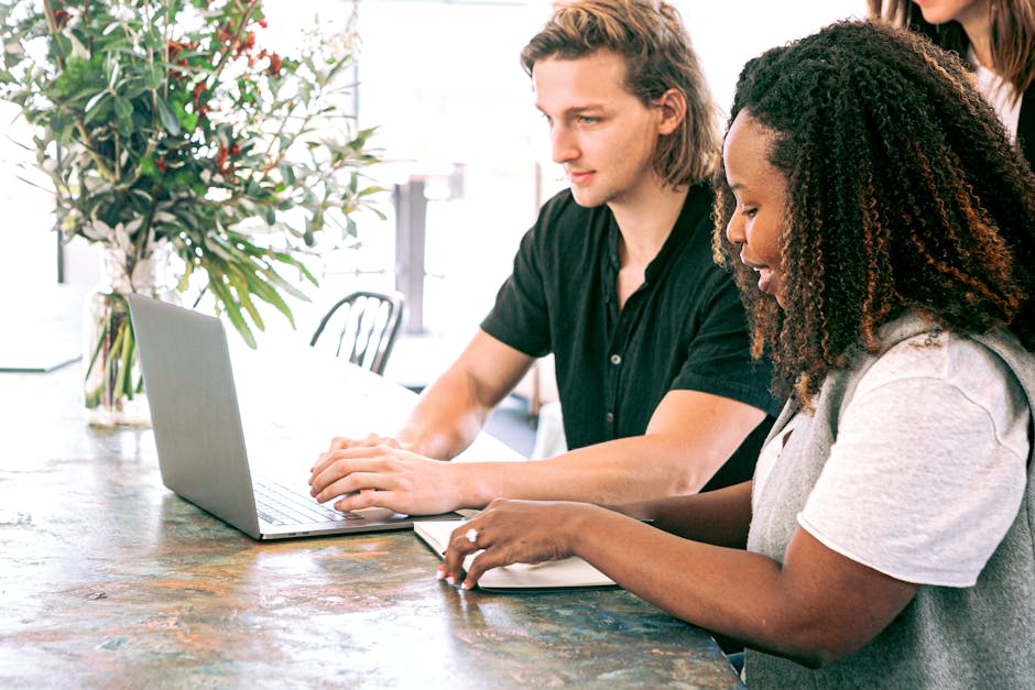 Young professionals collaborating on a project in a modern office space.