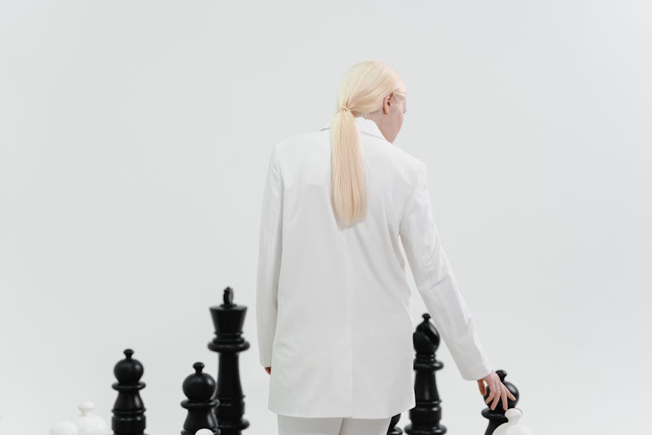 A fashionable woman in white plays a large-scale chess game, symbolizing strategy and intellect.