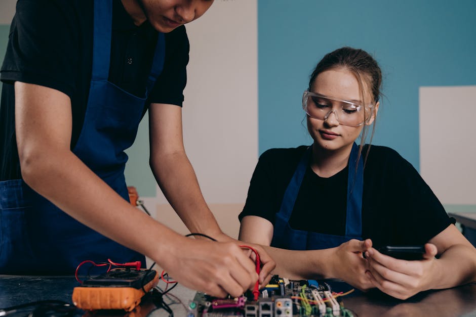 Two engineers testing electronic components in a workshop, focusing on device functionality.