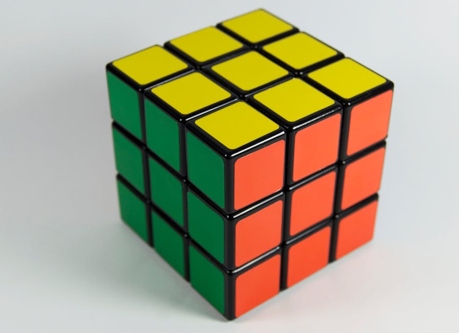 A solved Rubik's Cube displaying red, yellow, and green colors on a white backdrop. Perfect for puzzle enthusiasts.