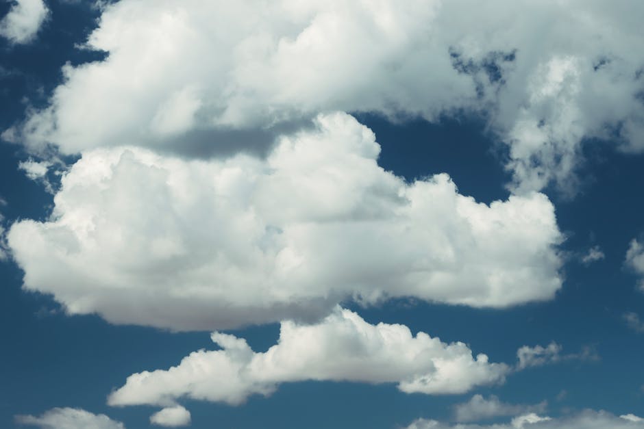 A stunning view of puffy white clouds floating in a clear blue sky above Naxos, Greece.