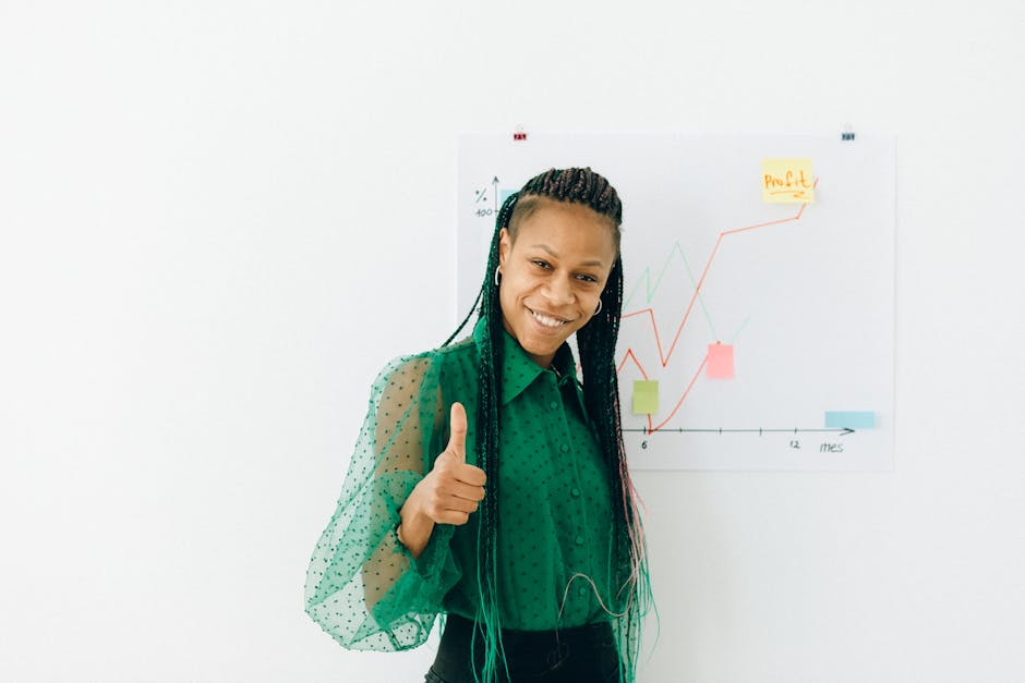 Smiling woman in green giving thumbs up with a profit chart in the background.